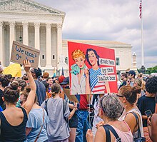 Demonstrators protesting the overturning of Roe v. Wade by the Supreme Court in June 2022. One protest sign reads, "Grab them by the ballot box."