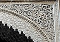 Arabesques carved in stucco over an archway in the al-Attarine Madrasa in Fes