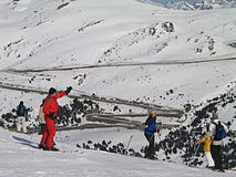 The pass, and a man on skis pointing using his ski pole