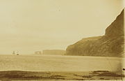 Baie de l'oiseau photographed by the aviso Eure on 2 January 1893, when France claimed the territory. The Kerguelen Arch is visible in the background.