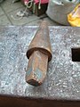 Hardy tool used to pierce hot metal beside the hardy hole