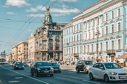 This is a photo of House of the company "Singer" (also known as "House of Books"), a cultural heritage object in Russia, located at the intersection of Nevsky Prospekt and the Griboyedov Canal, directly opposite the Kazan Cathedral. It is recognized as a historical landmark.