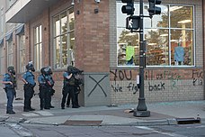 Police aim weapons during riots in St. Paul on May 28