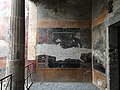 Fourth Style fresco with black ground on west wall of porticus
