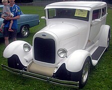 1928 Model A hot rod with roll pan, chopped top, and late-model headlights and mirrors