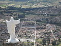 Christ with outstretched arms on the top of the town