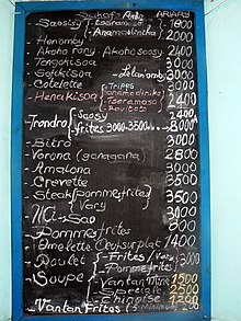 a list of meals and prices on a chalkboard