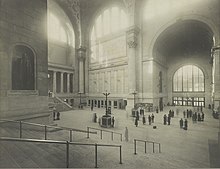The main waiting room with stairs in the foreground, and a statue of PRR President Alexander Johnston Cassatt on the left.