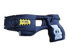 Black taser, pictured flat on its side, pointed left. Shaped like a typical handgun.