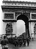German soldiers marching past the Arc de Triomphe after the surrender of Paris, 14 June 1940.