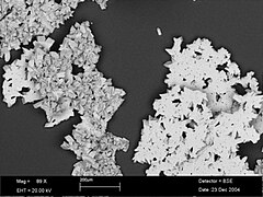 BSE-SEM image at 89 times magnification showing topsides of the calcite rafts (flat surfaces) and bottom crystals growing underneath
