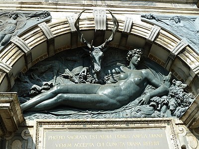 Replica of Benvenuto Cellini's relief, the Nymph of Anet, located over the portal