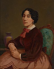 Oil painting portrait of Christiana Bannister. She sits on an upholstered chair and wears a brown skirt and blouse, with a red bow at her throat. She is clasping her hands and resting them on a nearby table.