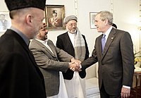 Karim Khalili, former 2nd Vice President of Afghanistan (with turban) is standing next to Mohammed Fahim, George W. Bush, facing Hamid Karzai.