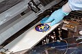C.O.L.B.E.R.T. logo being applied to the Combined Operational Load-Bearing External Resistance Treadmill at NASA before Launch