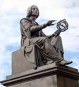 Copernicus holds a compass and armillary sphere.