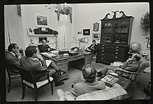 President Ford seated behind the C&O desk during a meeting