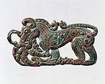 Belt plaque in the shape of a standing wolf, characteristic of nomadic artifacts of southern Ningxia and southeastern Gansu, and related to the Scythian styles of Pazyryk. 4th century BC.[107][103]