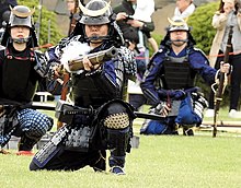 A member of the Matsumoto Castle Gun Corps, using an o-zutsu.