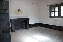 Color photograph of a large room with a fireplace in one of the walls.