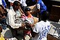 Internally displaced people receive humanitarian aid after an earthquake in Port-au-Prince, Haiti.