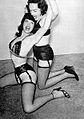 Circa 1950s, an Irving Klaw photograph of Bettie Page fighting another woman