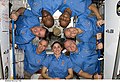 Melvin (upper left), Robert Satcher (upper right) and Nicole Stott form a crew photo circle in Node 2 during STS-129