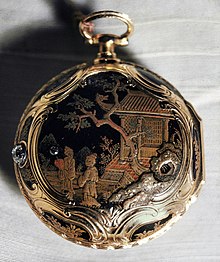 A pocket watch with an intricate Asian-themed design painted on it