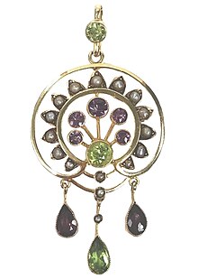An Art Nouveau era Suffragette pendant set with amethyst, pearl, and peridot.