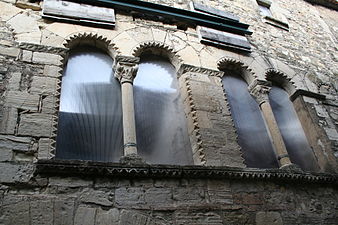 Details of the windows of a house in Villemagne l'Argentiere, France, showing chevroning and carved capitals.