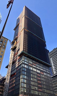 An image of 270 Park Avenue being demolished in 2019. Some windows have been removed, and there is scaffolding around the upper stories, which are being deconstructed.