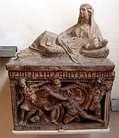 Etruscan funerary urn crowned with the sculpture of a woman and a front-panel relief showing two warriors fighting, polychrome terracotta, c. 150 BC