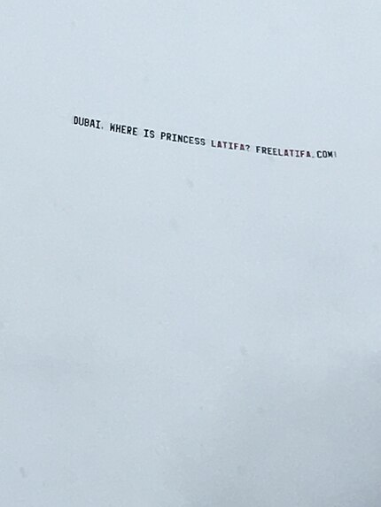 Banner against a cloudy sky, reading: DUBAI, WHERE IS PRINCESS LATIFA? FREELATIFA.COM