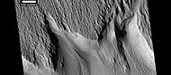 Surface features along a scarp in Medusae Fossae formation, as seen by HiRISE under HiWish program. Location is Memnonia quadrangle.