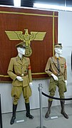Tapestry from the Reich Chancellery at the former International Museum of World War II, together with uniforms for a party leader and Sturmabteilung member.