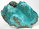 Intergrown botryoids of blue-green rosasite inside the curve of a limonite vug