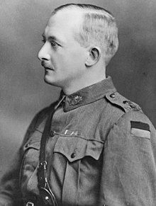 black and white side-on portrait photograph of a man in uniform