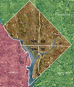 Color-enhanced USGS satellite image of Washington, D.C., taken April 26, 2002. The "crosshairs" in the image mark the quadrant divisions of Washington, with the U.S. Capitol at the center of the dividing lines. To the west of the Capitol extends the National Mall, visible as a thin green band in the image. The Northwest quadrant is the largest, located north of the Mall and west of North Capitol Street.