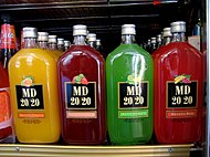 4 colorful MD 20/20 drink bottles on a shelf