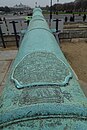 alt=Long cannon barrel with inscription in Arabic script <!~~