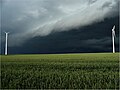 Storm with wind turbines in a corn field