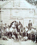 A historic b/w photo depicting miners in front of a mine entrance