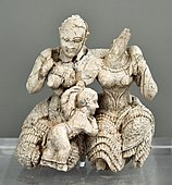 Two women and a child; 1400-1300 BC; ivory; height: 7.8 cm; National Archaeological Museum (Athens)[16]