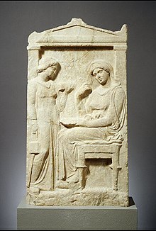 Photograph of an Ancient Greek marble grave marker, with the image of a woman.