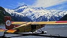 Photo of a small plane at an airport in the mountains