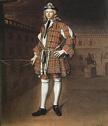 Oil portrait of a young man in a dress-like long tunic of red-and-black tartan, matching trews, blue bonnet with elaborate cockade, white hose, black buckled shoes, holding an unstrung bow