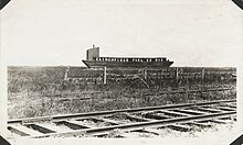 A coal barge lying upon a field of grass