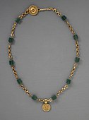 Necklace with a medallion depicting a goddess; 30–300 AD; green glass (the green beads) and gold; length: 43.82 centimetres (17.25 in); Los Angeles County Museum of Art