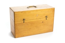 An upright rectangular wooden box with a hinged lid, clasp fastenings and a handle