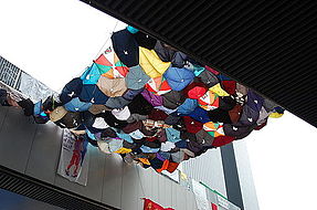 Umbrella art strung between two footbridges